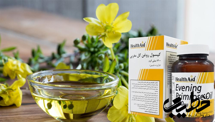 قرص روغن گل مغربی برند HealthAid در کنار کاسه‌ای حاوی روغن و گل‌های زرد طبیعی.